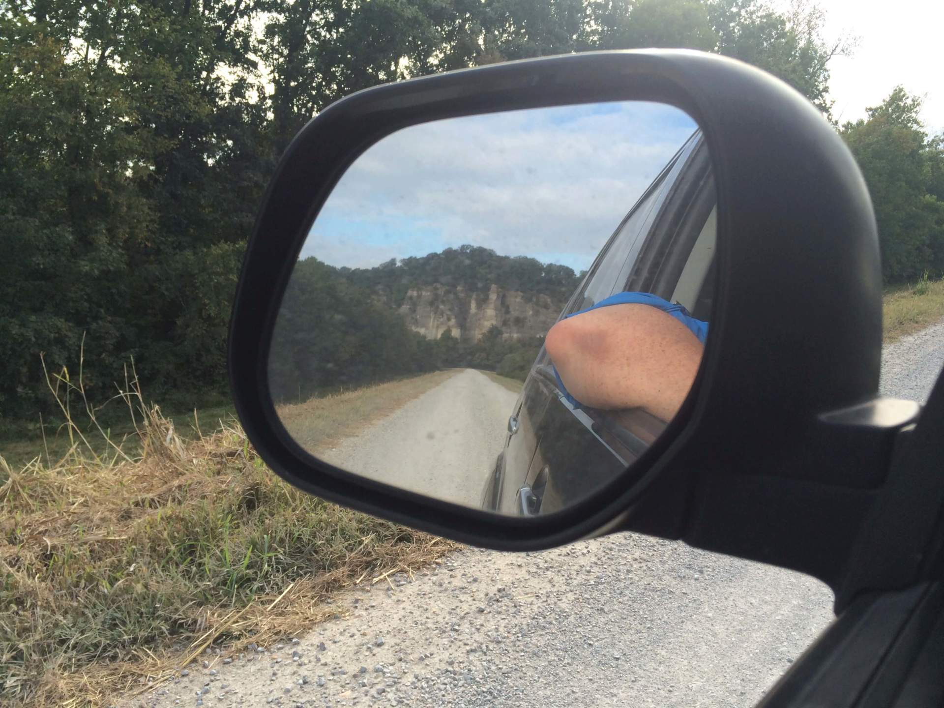 Car leaving with shawnee national forest showing in the rear mirror